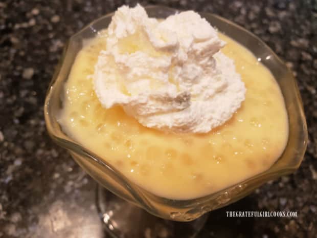 Each portion of tapioca pudding is topped with whipped cream before serving.