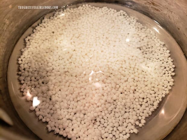 The tapioca pearls are soaking in a pan full of water.