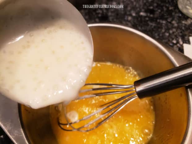 The egg mixture is tempered by drizzling in some hot pudding mixture a bit at a time.