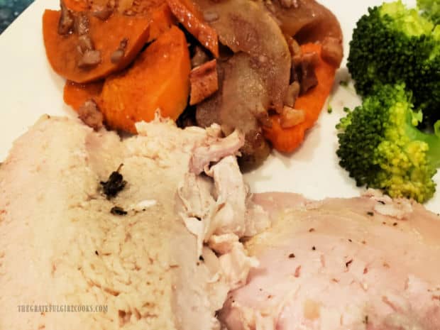 Turkey slices, along with broccoli and a sweet potato apple side dish are served on a white plate.