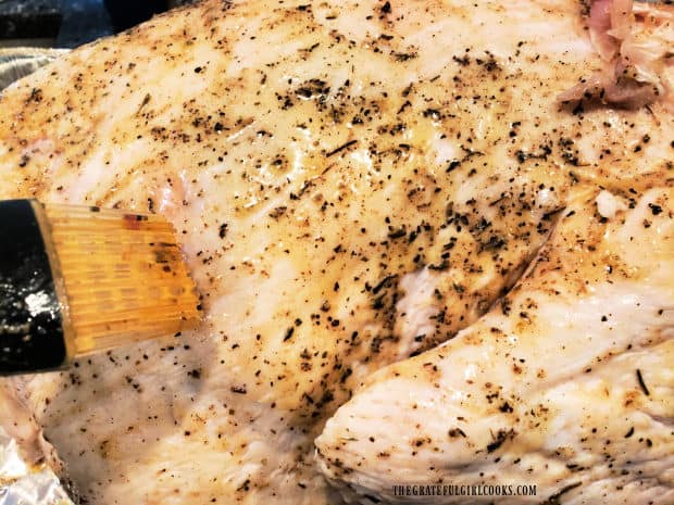 Butter and spice mixture is brushed over the surface of the turkey before it is cooked.