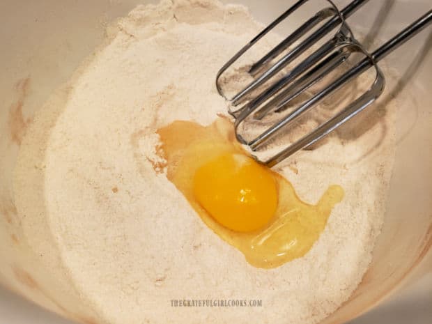 Dry ingredients are combined, then eggs are added and beaten in, one at a time.