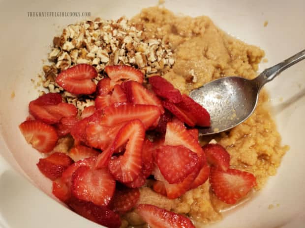 Sliced strawberries and chopped pecans (or walnuts) are stirred into the batter.