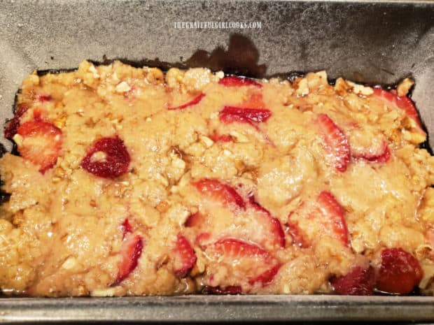 Bread batter is patted down in a 9x5" loaf pan before baking.