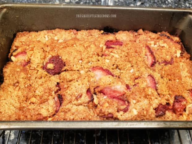After baking, the loaf of strawberry pecan bread cools before being removed from pan.