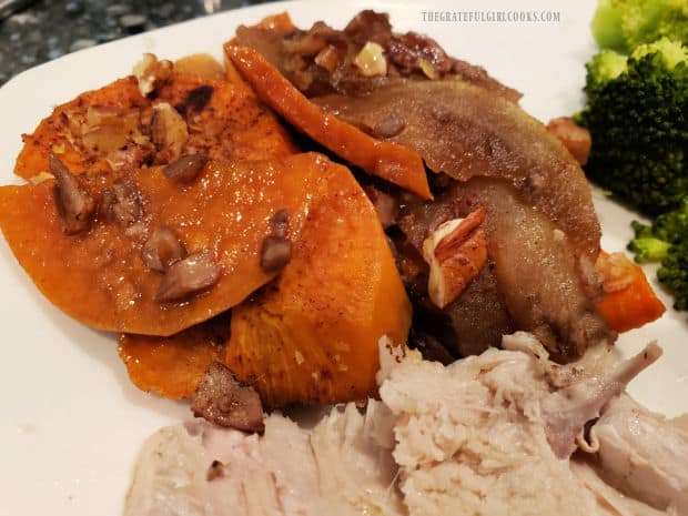 A portion of the sweet potato apple bake, served with turkey slice and steamed broccoli.