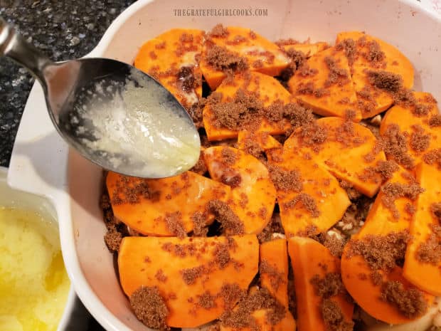 Melted butter is drizzled over the sweet potatoes.