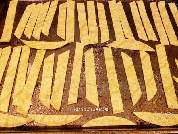 Half of the tortilla strips are sprayed with oil, then baked until crispy, for garnishing soup.