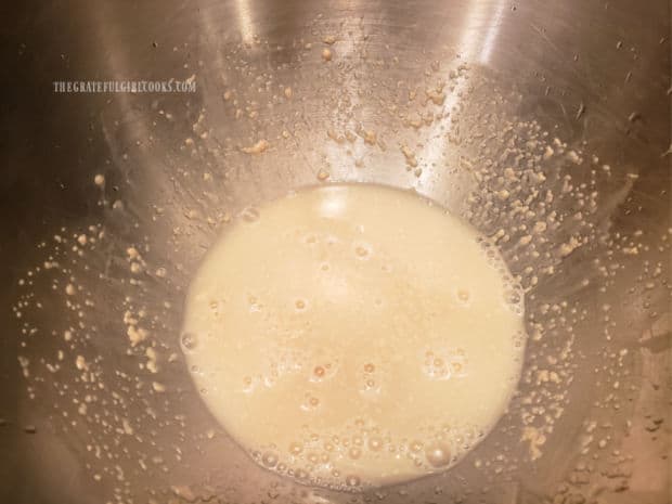 Yeast is bubbling in a small bowl, indicating the yeast is "good" to use.