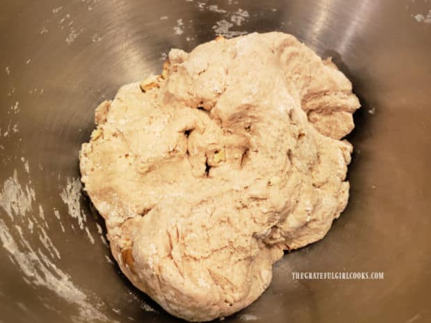 Ball of dough is placed in a greased large bowl, covered, and left to rise for 1 hour.