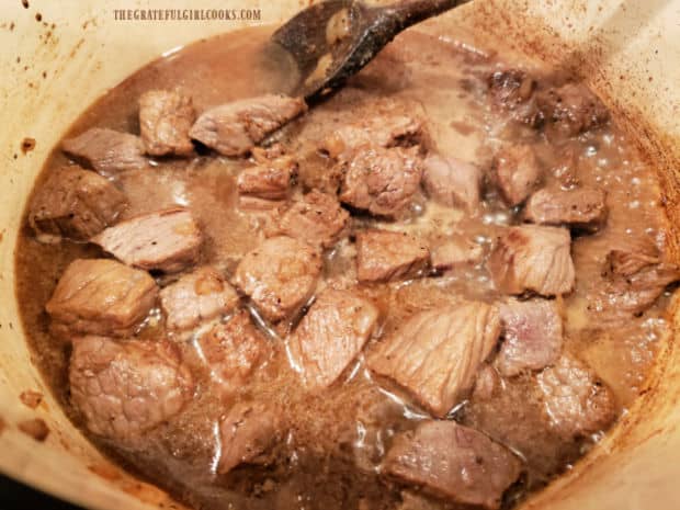 Beef broth is added to seasoned meat and onions in saucepan, then cooked for 90 minutes.