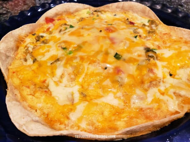 The chicken enchilada quiche is fully cooked, and cools for a few minutes before slicing.