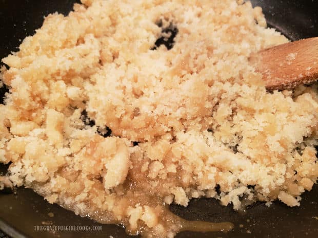 The granulated sugar begins to melt as it heats up in the skillet.
