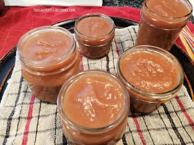 Pear butter is added to canning jars before adding to the water bath canner.