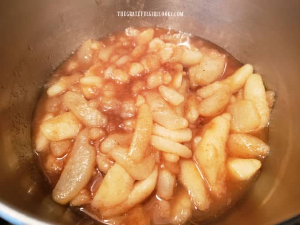 After pears cook for a few minutes, they are removed from the pan with a slotted spoon.