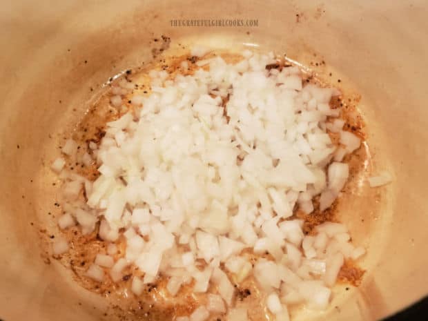 Chopped onions are cooked in saucepan until translucent and tender.