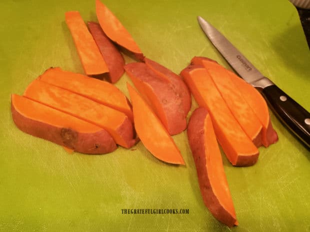 Fresh, unpeeled sweet potatoes are cut in wedges, then diced into cubes.