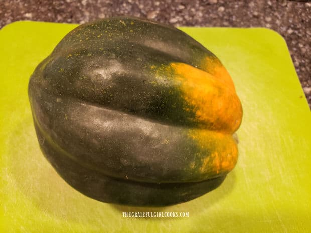 A medium sized acorn squash ready to slice in half for this recipe.