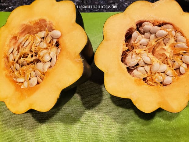 Seeds and pulp need to be removed from each of the acorn squash halves.