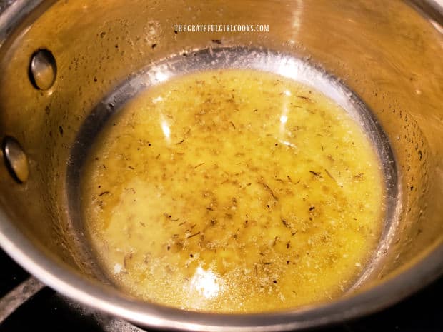 Spices are combined with melted butter in a small saucepan.