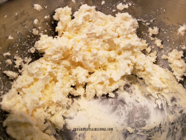Cream cheese and grated cheddar cheese are beaten together to make the filling.