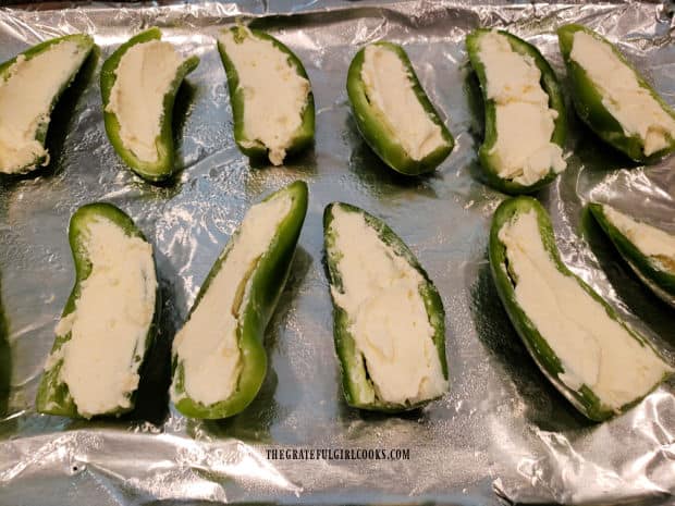 Jalapeño halves are stuffed with the cream cheese/cheddar filling.