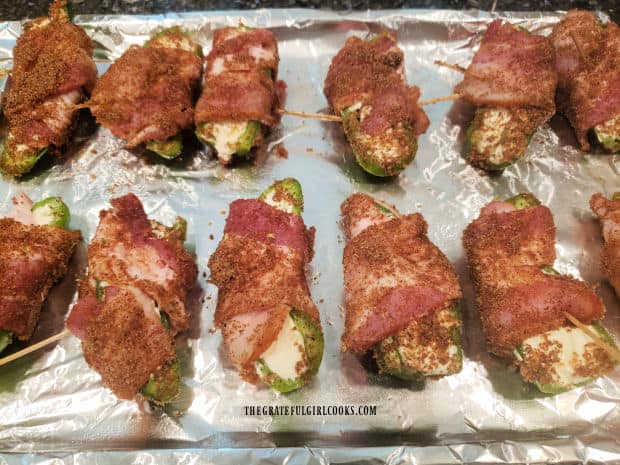 Bacon wrapped jalapeño poppers are coated in a brown sugar-chili mix seasoning before baking.