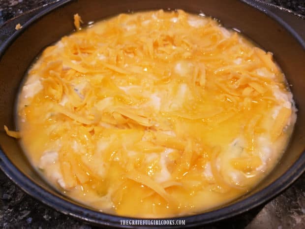 Melted butter is added to the top of the batter for the cheesy bread wedges.