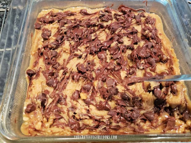 Chocolate chips are swirled through the dough, then pan is put back in oven to finish baking.