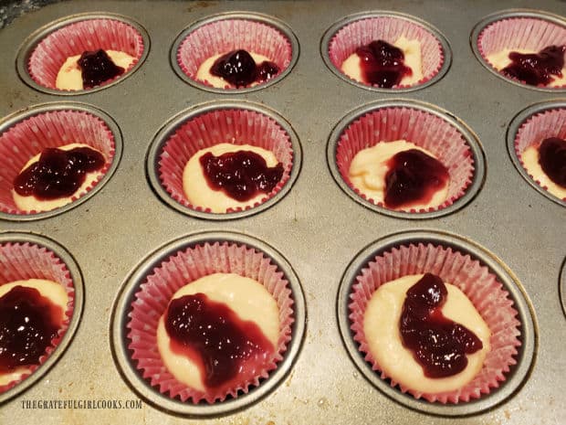 Raspberry jam (regular or seedless) is spooned on top of the muffin batter.