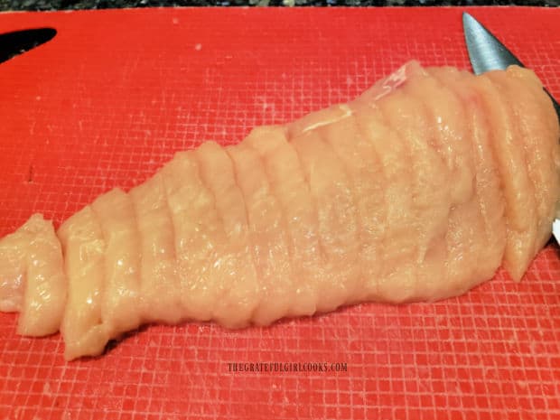 Chicken breasts are cut into 1/4" long slices before marinating.