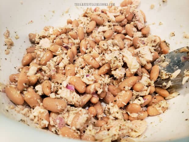 After mixing in the salad dressing, the salad is ready to be served.