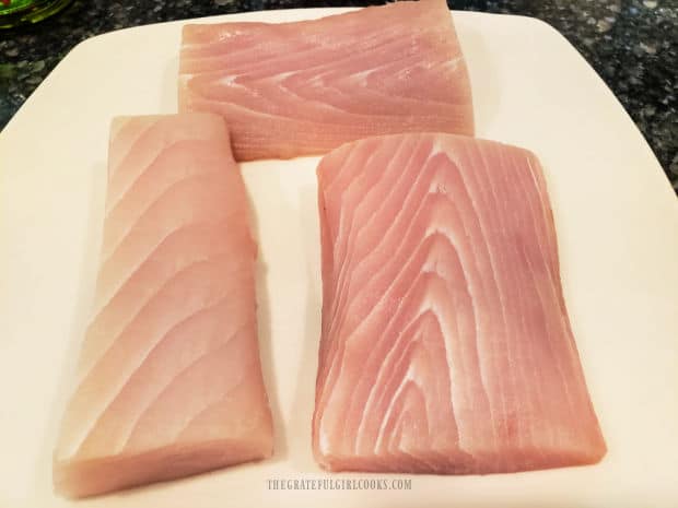 Mahi Mahi fillets are dried off with paper towels then wait to be breaded.