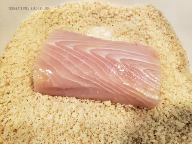 The oiled Mahi Mahi fillets are coated, one at a time in seasoned panko breadcrumbs.