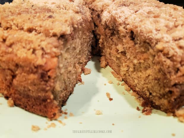 The banana streusel coffeecake is cut into wedge shaped pieces before serving.
