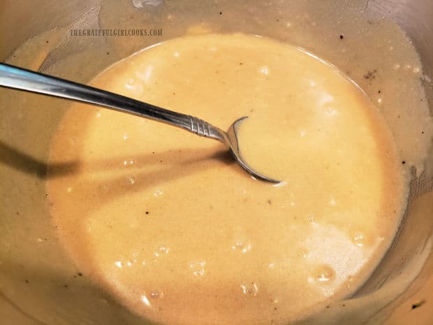 Mashed bananas are added to the batter and mixed until the batter becomes smooth and thick.
