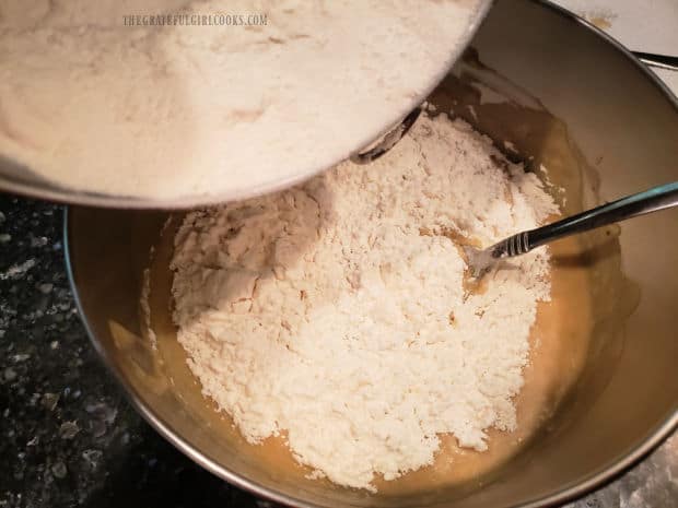 The flour mixture is then added, a little at a time, to the wet banana batter.