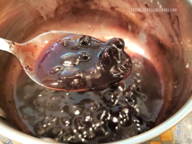 The blueberry dessert sauce is cooked until it has slightly thickened, then it's cooled.