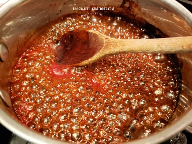 Sauce for the chicken burgers is cooked until bubbly and reduced in volume.