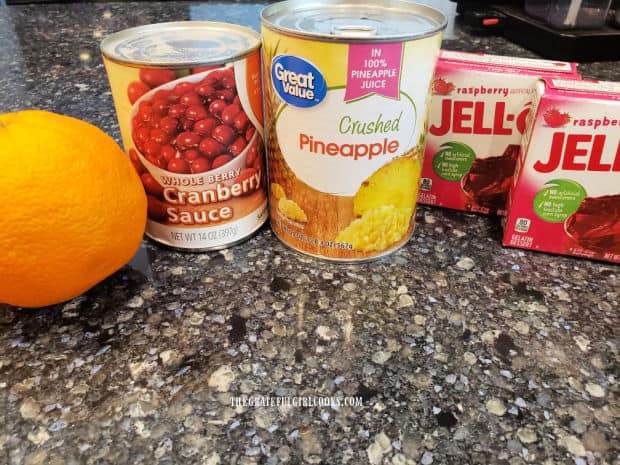 Orange zest, whole cranberry sauce, crushed pineapple and raspberry gelatin are the ingredients needed.