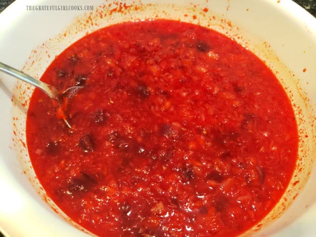 The cranberry pineapple jello salad mixture is combined and ready to pour into serving dish. 