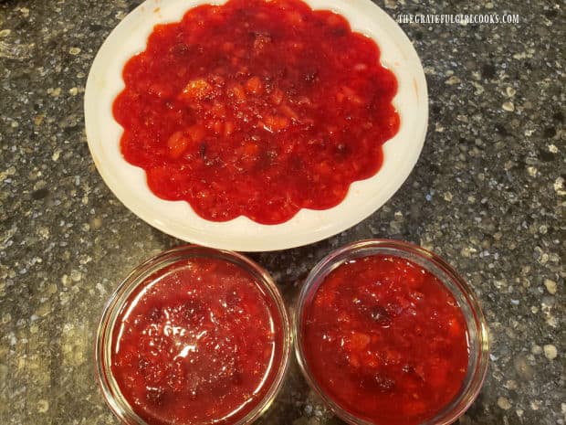 Jello mold and 2 custard cups, filled with cranberry pineapple jello salad, ready to refrigerate.