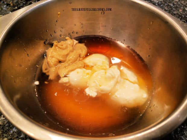 Vinaigrette ingredients are measured into a medium sized bowl for mixing.