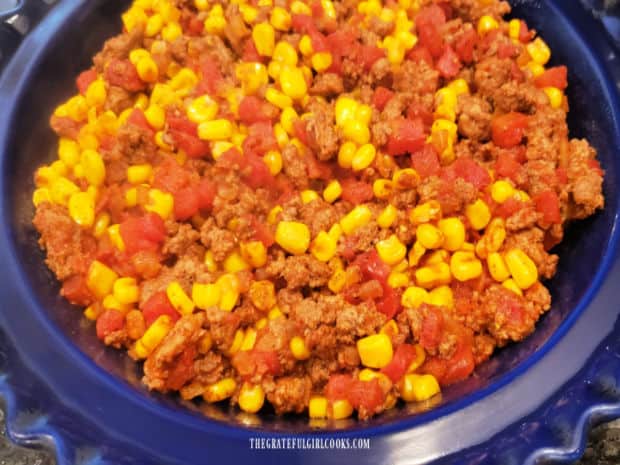 Filling for the easy tamale pie is spread into a deep dish pie pan.