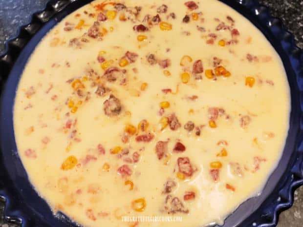 Cornbread-style batter is poured on top of the beef tamale pie filling before baking.