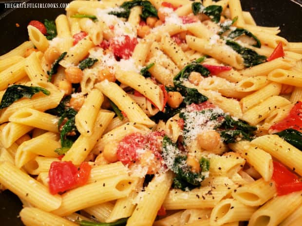 Grated Parmesan is added and combined with the Garlic Penne Pasta And Veggies, then served.