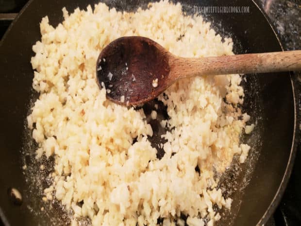 Riced cauliflower is added to melted butter and garlic and cooked for a couple minutes.