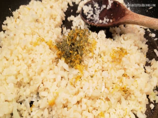 Chicken broth, dried parsley, Italian seasoning, and lemon zest is added to season the cauliflower rice.