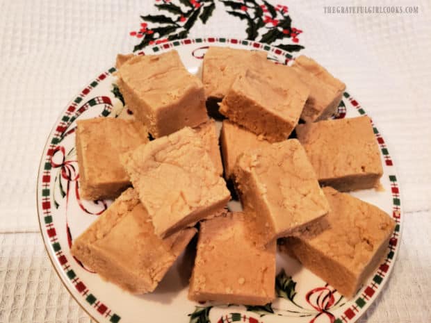 A Christmas plate with several pieces of peanut butter fudge, ready to enjoy.