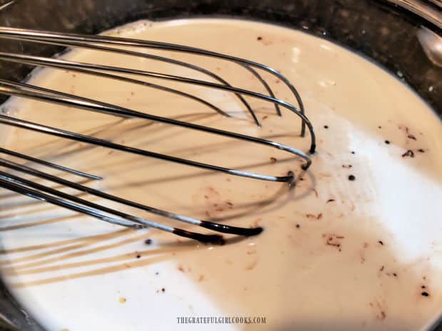 Using a whisk to combine all the ingredients for the coffee creamer.